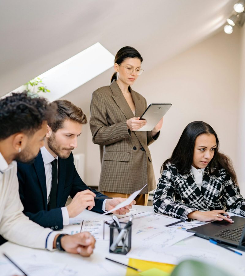 A diverse team working together in a bright office space, collaborating on a project.
